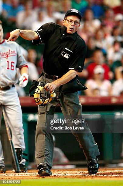 Home plate umpire Bill Hohn throws pitcher Roy Oswalt of the Houston Astros out of the game in the third inning for complaining about the strike zone...