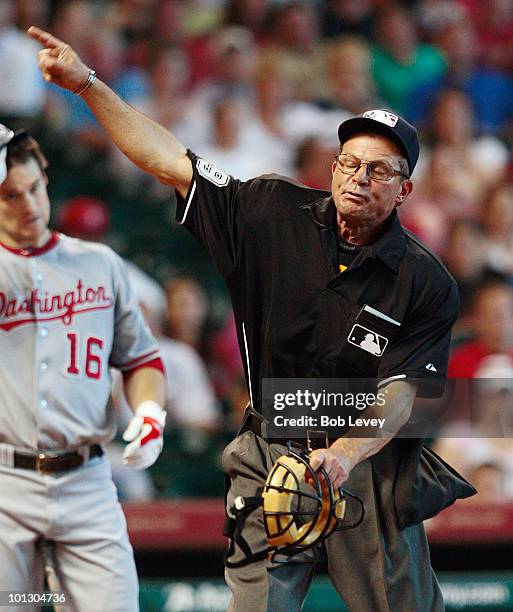 Home plate umpire Bill Hohn throws pitcher Roy Oswalt of the Houston Astros out of the game in the third inning for complaining about the strike zone...