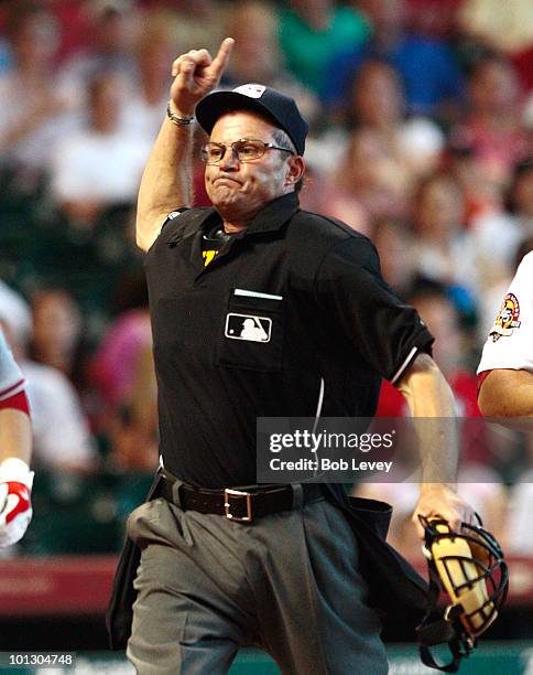 Home plate umpire Bill Hohn throws pitcher Roy Oswalt of the Houston Astros out of the game in the third inning for complaining about the strike zone...