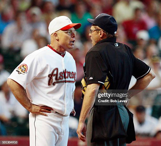 Manager Brad Mills of the Houston Astros argues with home plate umpire Bill Hohn after Hohn ejected pitcher Roy Oswalt in the third inning for...