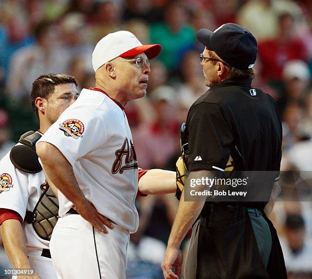 Manager Brad Mills of the Houston Astros argues with home plate umpire Bill Hohn after Hohn ejected pitcher Roy Oswalt in the third inning for...