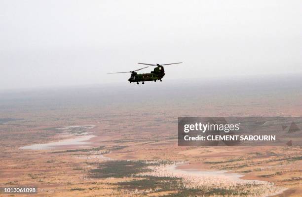 This aerial view shows a Canadian UN peacekeeping helicopter during a patrol over Gao on July 31 part of the United Nations Multidimensional...