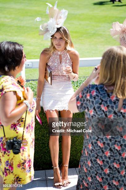 Stylish racegoer wearing fascinator beside the Parade Ring, 'Ladies Day' at "Glorious Goodwood" - The Qatar Goodwood Festival at Goodwood Racecourse,...