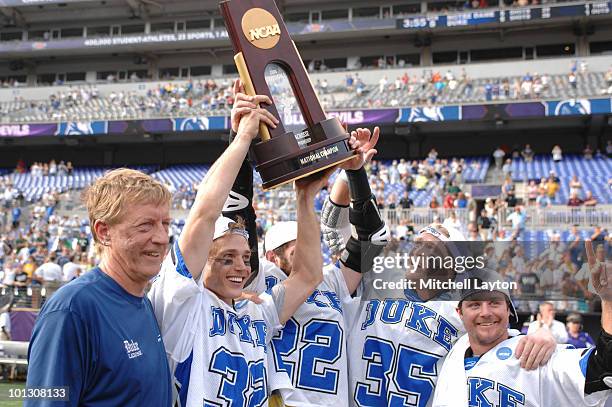 Head coach John Danowski, Sam Payton, Ned Crotty, Parker McKee, and Max Quinzani of the Duke Blue Devils celebrate winning the 2010 NCAA Division 1...