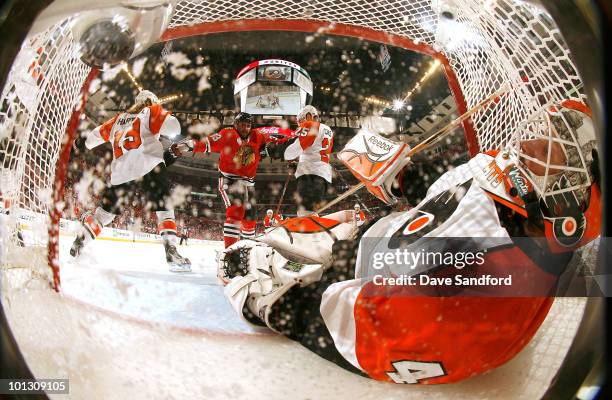 Goaltender Michael Leighton of the Philadelphia Flyers leans back to cover the puck in the net during the first period of Game Two of the 2010 NHL...