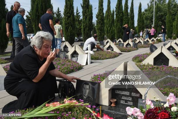 Relatives of Georgia's servicemen killed during the 2008 brief war with Russia over control of South Ossetia mourn during a ceremony on the 10th...