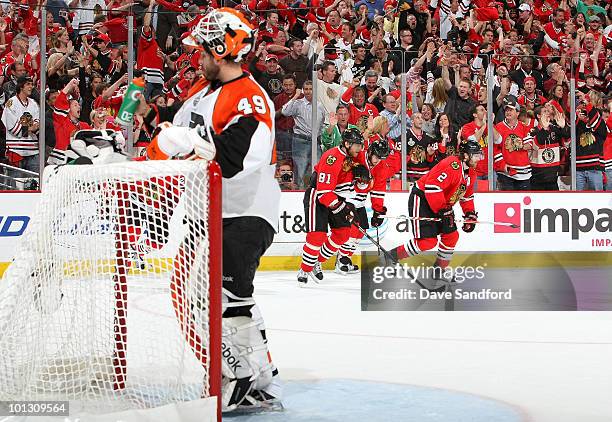 Goaltender Michael Leighton of the Philadelphia Flyers takes a drink as the Chicago Blackhawks celebrate a goal by Marian Hossa during the second...