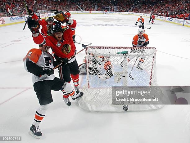 Marian Hossa of the Chicago Blackhawks celerbrates after scoring a goal past Michael Leighton and Lukas Krajicek of the Philadelphia Flyers in the...