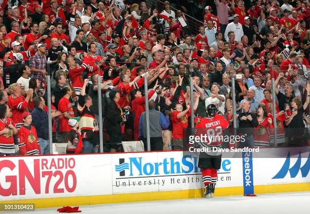 Tomas Kopecky of the Chicago Blackhawks throws his stick over the glass to fans in celebration of his teams 2-1 victory in Game Two of the 2010 NHL...
