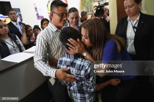 Guatemalan First Lady Patricia Marroqun kisses Abner Raul, 10 after he was reunited with his family at the Nuestras Raices immigrant center on a on...