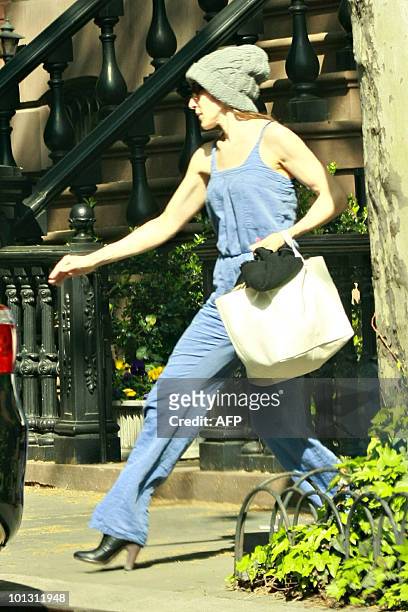 Actress Sarah Jessica Parker leaves her house dressed as a mild-mannered, every day woman, carrying her superhero dress to a 'Sex and the City' press...