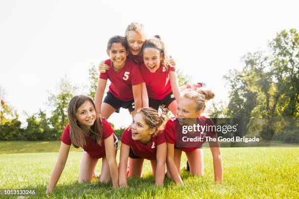 soccer players making a human pyramid on field - human pyramid stock pictures, royalty-free photos & images