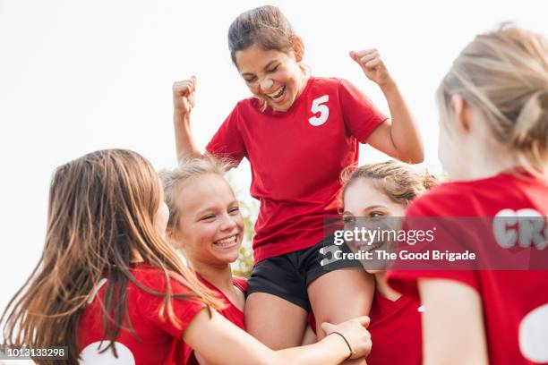 girls soccer team celebrating victory - playing to win bildbanksfoton och bilder