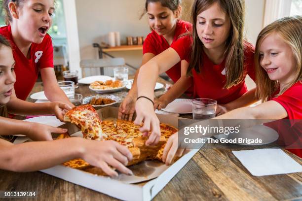 group of girls having pizza party at home - american pizza stock pictures, royalty-free photos & images