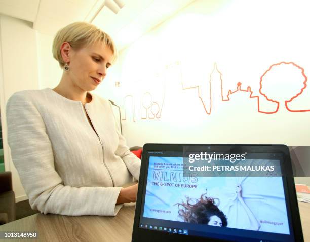 Inga Romanovskiene, director of official tourism service Go Vilnius stands behind a laptop displaying the homepage of a publicity campaign to promote...