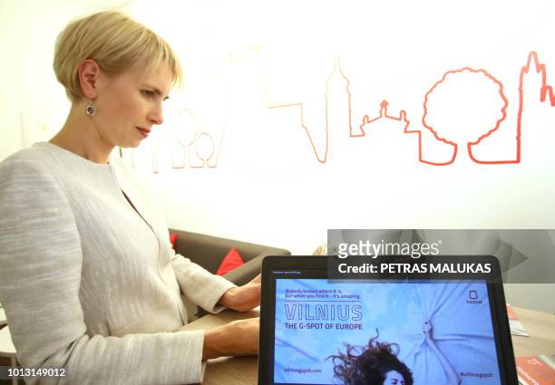 Inga Romanovskiene, director of official tourism service Go Vilnius stands behind a laptop displaying the homepage of a publicity campaign to promote...