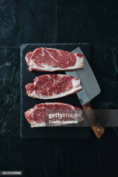 raw fresh beef steak on dark background - sirloin-steak stock pictures, royalty-free photos & images