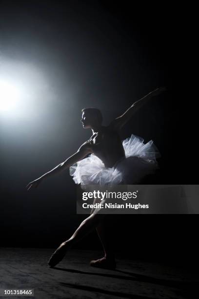 ballerina performing on stage under spotlight - pointe stock pictures, royalty-free photos & images