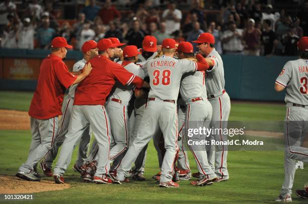 Pitcher Roy Halladay of the Philadelphia is mobbed by his teammates after pitching a perfect game against the Florida Marlins in Sun Life Stadium on...