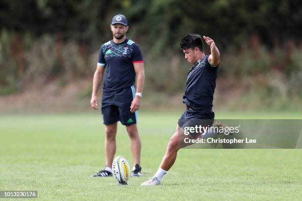 Marcus Smith of Harlequins kicks as he is watched by Nick Evans during the Harlequins Pre-Season Training Session at Surrey Sports Park on August 8,...