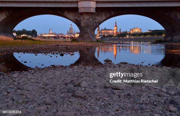 Low water level of Elbe river is seen near Dresden`s old town district during hot weather on August 7, 2018 in Dresden, Germany. A heat wave and dry...