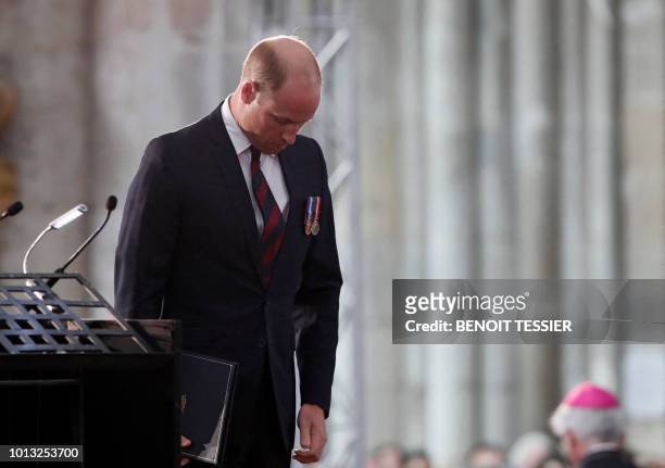 Britain's Prince William, the Duke of Cambridge, bows his head as he attends a religious ceremony to mark the 100th anniversary of the World War I...