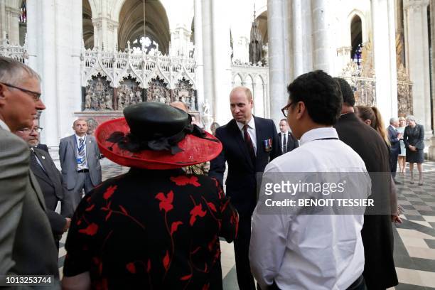 Britain's Prince William, the Duke of Cambridge , speaks with relatives of soldiers who took part in the Battle of Amiens after a religious ceremony...