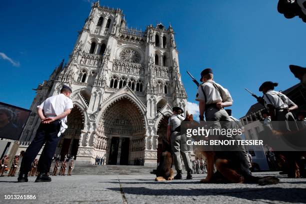 French soldiers and their dogs stand outside the Amiens Cathedral after a religious ceremony to mark the 100th anniversary of the World War I Battle...