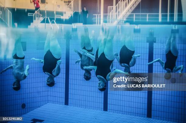 Participants compete in the synchronized swimming contest during the 10th edition of the international Gay Games at the Maurice Thorez swimming pool...