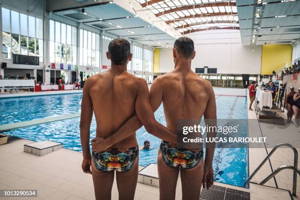 Participants wait for results during the synchronized swimming contest during the 10th edition of the international Gay Games at the Maurice Thorez...