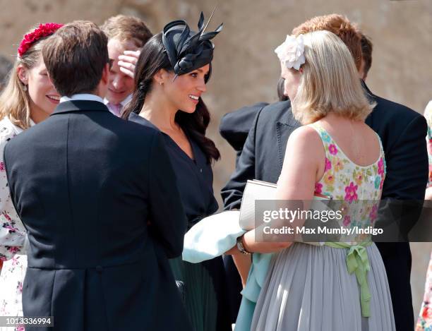 Meghan, Duchess of Sussex talks with Celia McCorquodale as she attends the wedding of Charlie van Straubenzee and Daisy Jenks at the church of St...