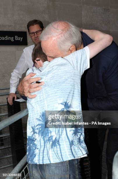 Actor John Cleese hugs a young fan outside BBC Broadcasting House in London, after appearing on The One Show with his daughter Camilla Cleese.