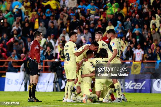 Oribe Peralta of America celebrates with teammates after scoring the third goal of his team with his teammates during the third round match between...