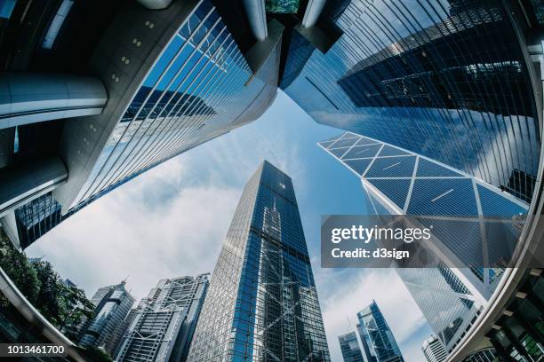 low angle view of modern architectural design of compact financial skyscrapers in busy central business district in the morning - hong kong sunrise stock pictures, royalty-free photos & images