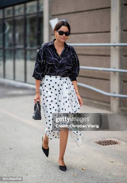 Funda Christophersen wearing white skirt with dots print is seen outside J.Lindeberg during the Copenhagen Fashion Week Spring/Summer 2019 on August...