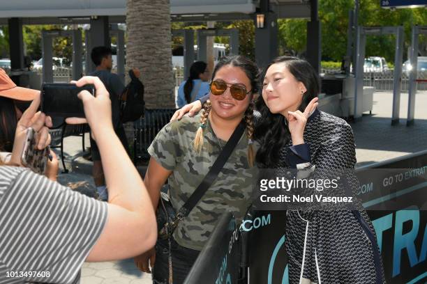 Awkwafina poses with a fan at "Extra" at Universal Studios Hollywood on August 8, 2018 in Universal City, California.