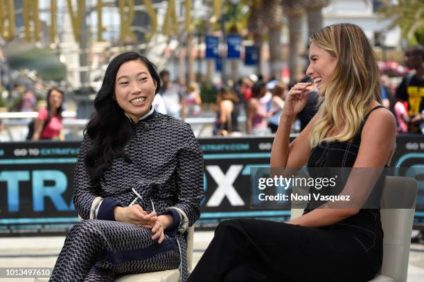 Awkwafina and Renee Bargh visit "Extra" at Universal Studios Hollywood on August 8, 2018 in Universal City, California.