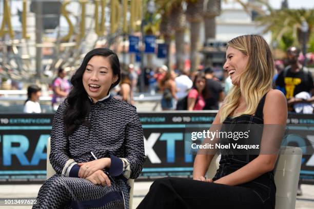 Awkwafina and Renee Bargh visit "Extra" at Universal Studios Hollywood on August 8, 2018 in Universal City, California.