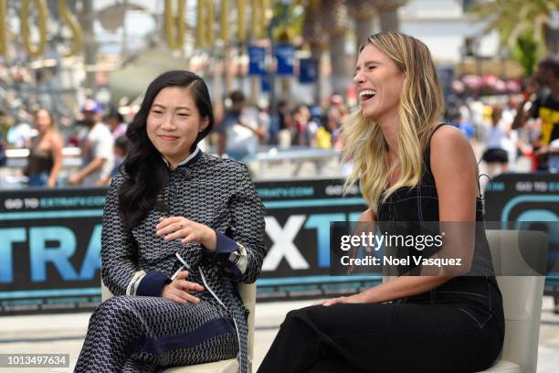 Awkwafina and Renee Bargh visit "Extra" at Universal Studios Hollywood on August 8, 2018 in Universal City, California.