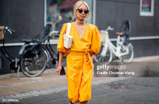 Vanessa Hong wearing yellow dress is seen outside Stine Goya during the Copenhagen Fashion Week Spring/Summer 2019 on August 8, 2018 in Copenhagen,...