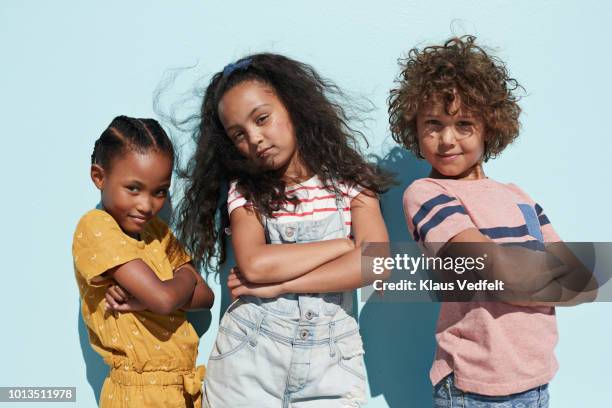 portrait of 3 cool kids together on blue backdrop in summer - portrait young colour background cool stockfoto's en -beelden