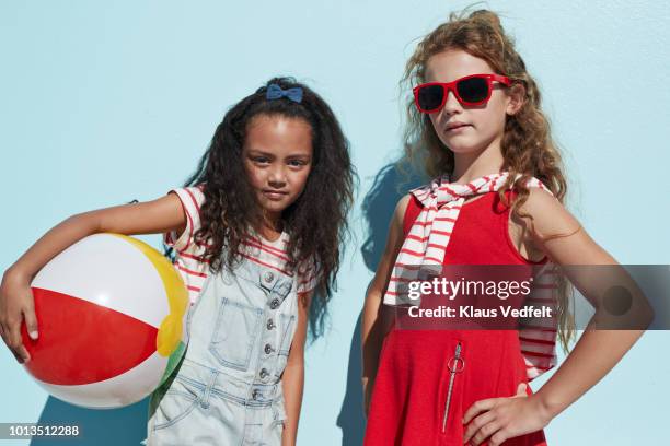 portrait cool girls together on blue backdrop in summer - kids fashion stock pictures, royalty-free photos & images