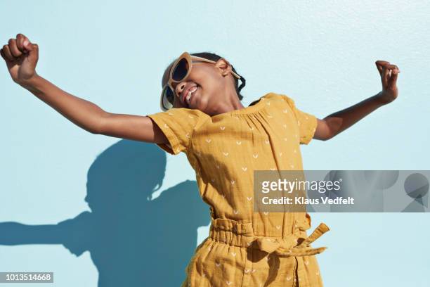 portrait of jumping cool girl with sunglasses - kids fashion stockfoto's en -beelden