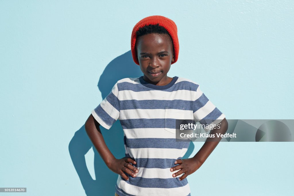 Portrait of cool boy looking in camera, on studio background