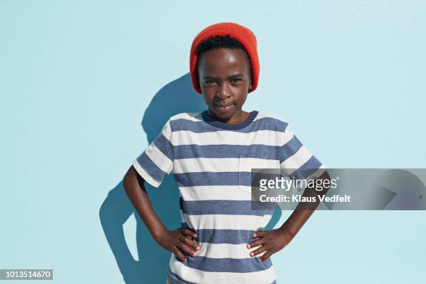 portrait of cool boy looking in camera, on studio background - childs pose stockfoto's en -beelden