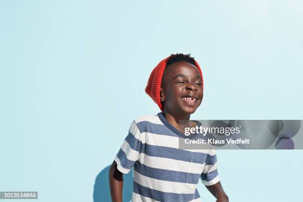 portrait of cool boy laughing , on studio background - fashion kids stock-fotos und bilder