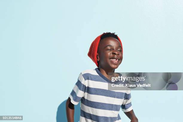 portrait of cool boy laughing , on studio background - kids fashion stockfoto's en -beelden
