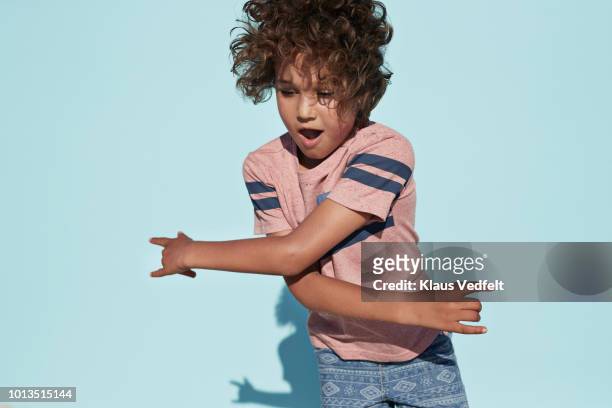 portrait of cool boy dancing, on studio background - child kid series expressions imagens e fotografias de stock