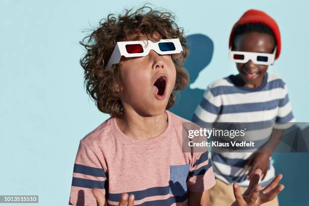 group shot of cool kids wearing 3-d glasses while playing and posing - lunettes 3d photos et images de collection