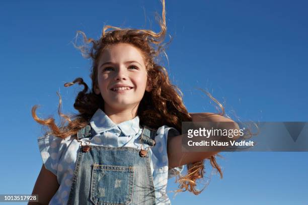 child on beach by the ocean - brown hair blowing stock pictures, royalty-free photos & images